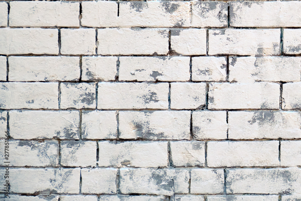 Fototapeta premium The background of masonry stones of different sizes painted in white. Texture retro bricks are painted. White brick wall, texture.