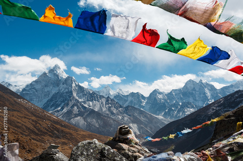 Evverest trekking. Beautiful view of the valley of Nepal. In the frame of the mountain and prayer flags of Nepalese with prayers. Nepal.
