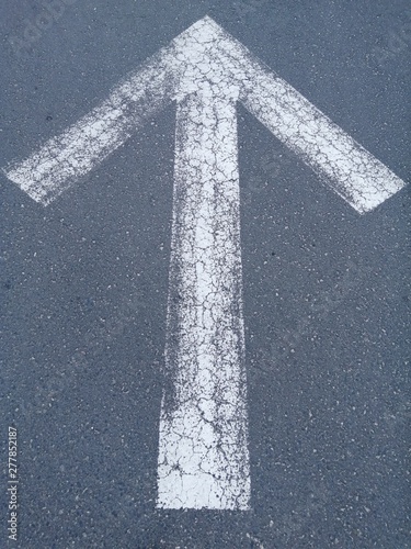 White Arrow.Forward signs on the road.Grey background