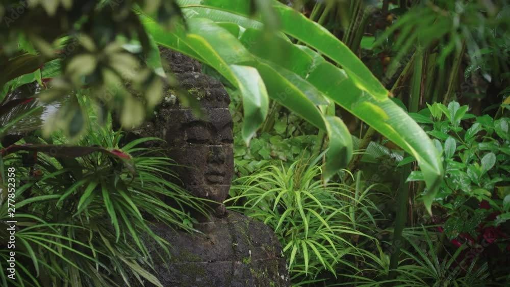 Buddha Statue fountain covered in moss in the rain. Ubud, Bali Buddha Statue fountain covered in moss in the rain. Ubud, Bali