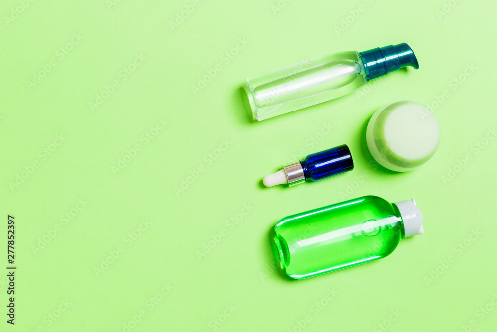 Cosmetics SPA branding mock-up, top view with copy space. set of tubes and jars of cream flat lay on gren background Cosmetics SPA branding mock-up, top view with copy space. set of tubes and jars of cream flat lay on gren background