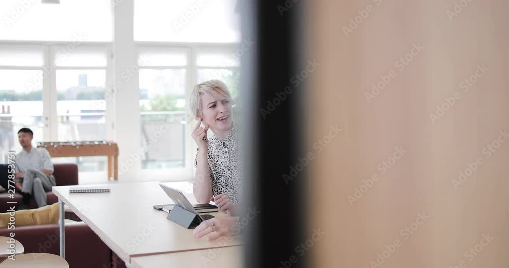 Coworkers in a meeting using a digital tablet Coworkers in a meeting using a digital tablet