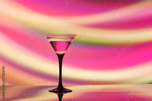 colourful cocktail on the club light background.