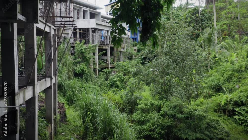 Aerial: illegal construction of hotels amongst a tropical rainforest. Ubud, Bali, Indonesia. Aerial: illegal construction of hotels amongst a tropical rainforest. Ubud, Bali, Indonesia.