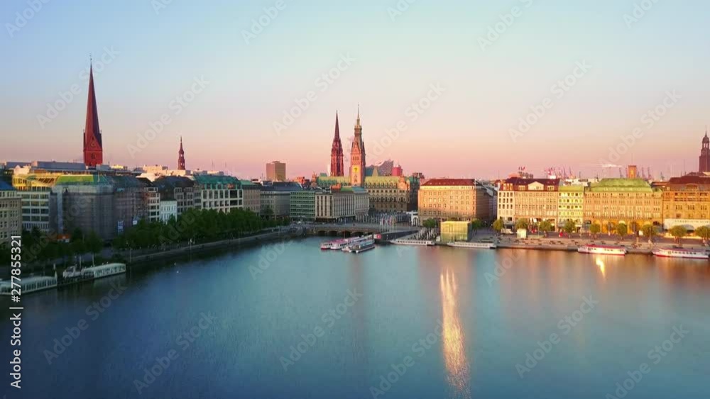 hamburg aerial view at sunrise drone flying low over alster lake rising up over city skyline reveal shot hamburg aerial view at sunrise drone flying low over alster lake rising up over city skyline reveal shot