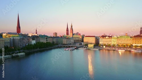 hamburg  aerial view at sunrise drone flying low over alster lake rising up over city skyline reveal shot photo