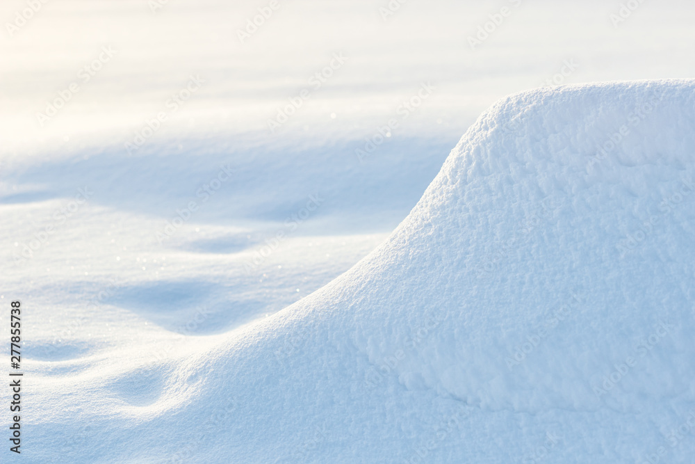 snowdrift winter background with snow and blurred bokeh.