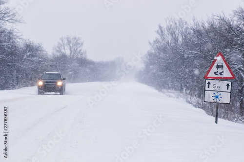 Cars with winter tires on snow-covered road
