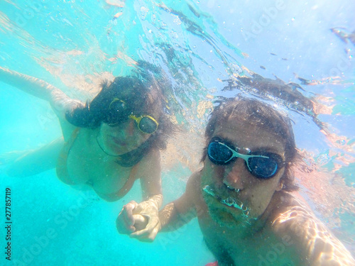 Couple having fun underwater in the sea