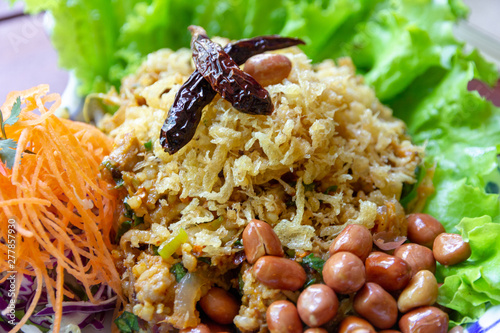Obraz na plátně Yam Naem Khao Thot is Spicy Salad of Curried Rice Croquettes, Fermented Pork, Ginger and Peanuts on plate