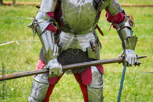 A medieval knight in amrour holding a weapon