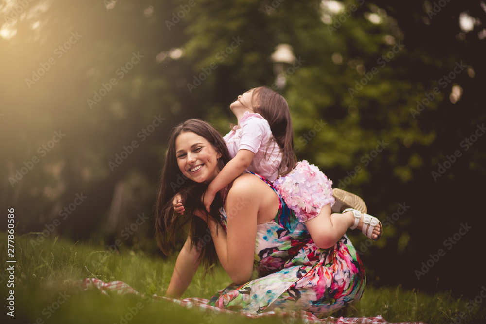 Fototapeta premium This is fun. Mother and daughter in nature.