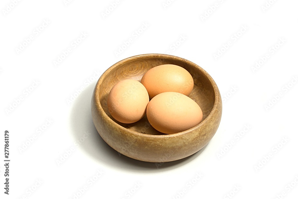 eggs in wooden bowl isolated on white background eggs in wooden bowl isolated on white background