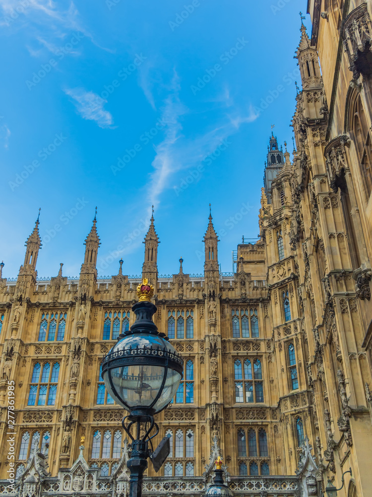 Fototapeta premium View of the Westminster Palace and the Houses of Parliament building facade against the blue sky, London, UK.