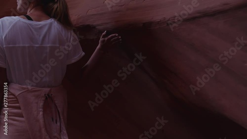 TRACKING Caucasian female exploring Antelope Canyon, Arizona. 4K UHD RAW edited footage