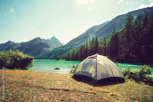 Camping tent with lake background. rest or vacation in the wild in Siberia in Altai. outdoor activity. the concept of Hiking photo