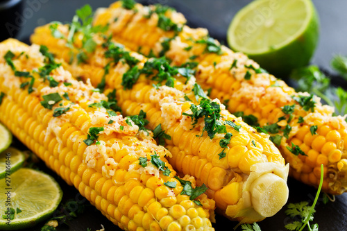 Boiled corn with mexican spices, butter, cilantro.