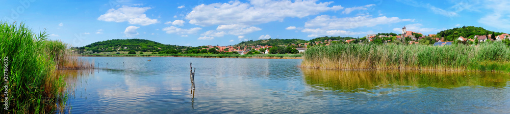 Panoramic photo of Tihany village on the hills with the inner lake and reed in the foreground at lake Balaton in Hungary