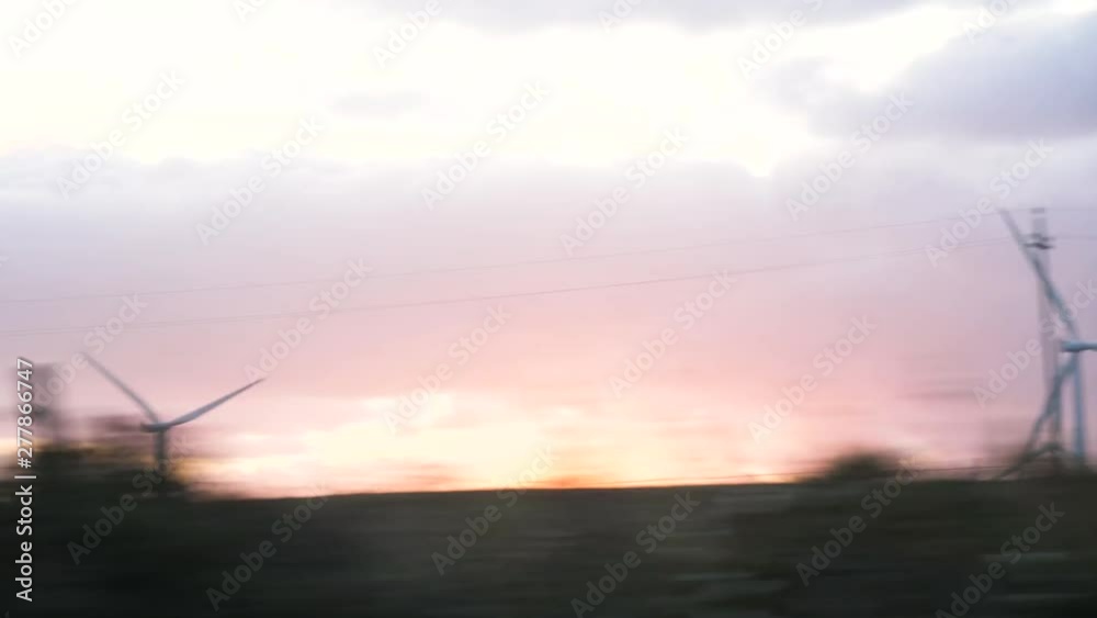 SLOW MOTION Wind turbines clean energy at sunset SLOW MOTION Wind turbines clean energy at sunset