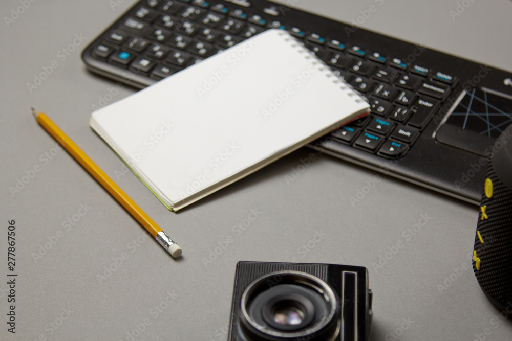 workplace blogger. set to prepare for public speaking and writing text: keyboard, notebook, pencil, camera, top view workplace blogger. set to prepare for public speaking and writing text: keyboard, notebook, pencil, camera, top view