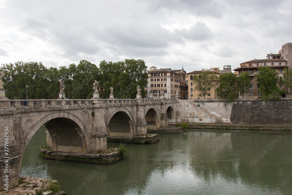 Ponte Sant'Angelo or Aelian Bridge with rainy clouds on background, Rome, Lazio, Italy.