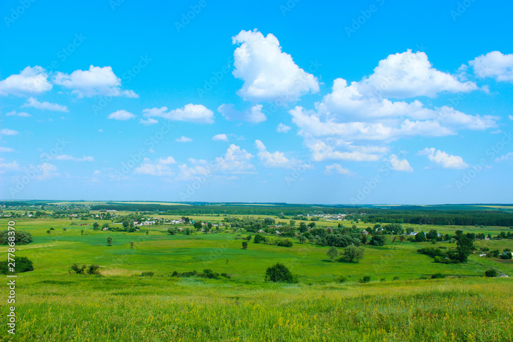 Green field and blue sky background. Landscape, nature concept. Nature Background.