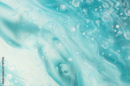 under the water surface floating sexy woman body with waves and bubbles