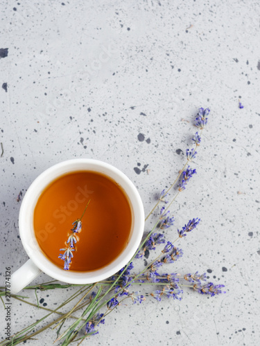 White Cup with lavender tea on stone table with copyspace