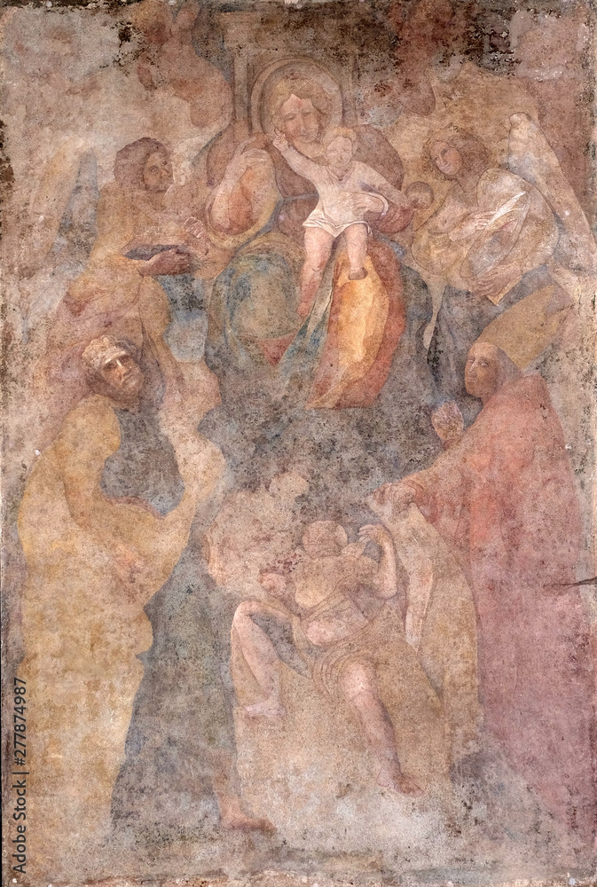 Naklejka premium Virgin Mary with baby Jesus and Saints fresco on Palazzo Pretorio or Palazzo del Podesta in Lucca, Tuscany, Italy