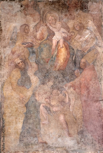 Virgin Mary with baby Jesus and Saints fresco on Palazzo Pretorio or Palazzo del Podesta in Lucca, Tuscany, Italy