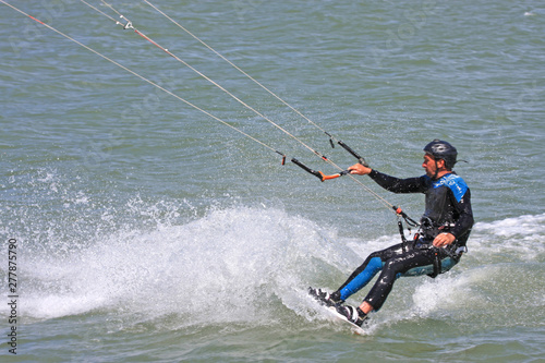 kitesurfer riding his board