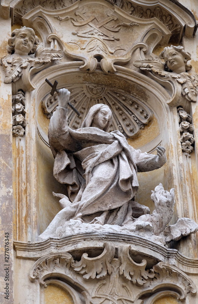 Statue of Saint Martha of Bethany on facade of Santa Maria Maddalena Church in Rome, Italy 