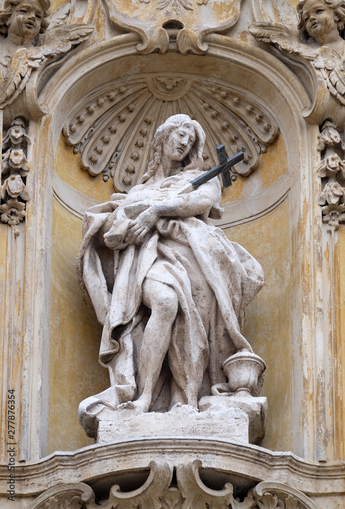 Statue of Saint Mary Magdalene on facade of Santa Maria Maddalena Church in Rome, Italy 