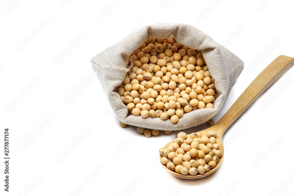 Soybeans in sack bag and wooden spoon isolated on white background. Soybeans in sack bag and wooden spoon isolated on white background.