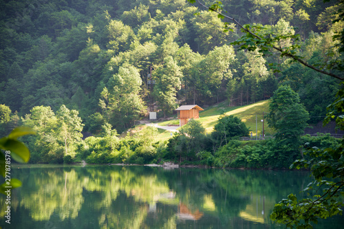 Monte Croce, Italy, 06/20/2019 , red barn  near Canali creek along the street to Fiera di Primiero, picturesque beautiful town on italian Alps. photo