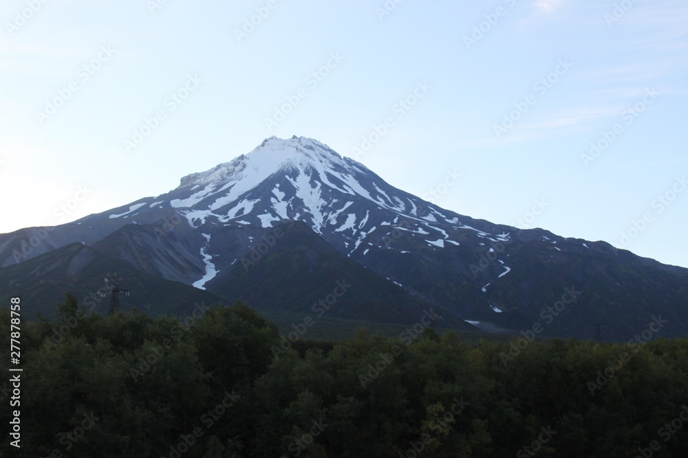 The top of the volcano in Kamchatka is shrouded in vapors, a beautiful mountain landscape.