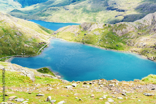 Fototapeta Naklejka Na Ścianę i Meble -  View of beautiful blue lakes in Snowdonia National Park, North Wales, mountains on the back, selective focus