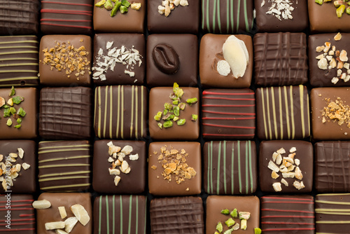 chocolates praline variety in row, closeup.