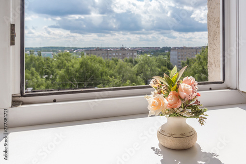 Open window and flower on the window