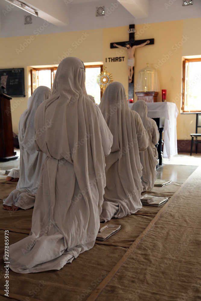 Sisters of Mother Teresa's Missionaries of Charity in prayer in the chapel of the Mother House, Kolkata, India 