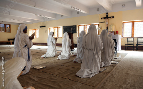 Sisters of Mother Teresa's Missionaries of Charity in prayer in the chapel of the Mother House, Kolkata, India  photo