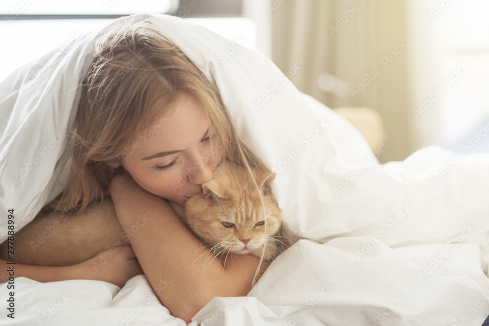 Her best friend. Beautiful girl plays with a cat on the bed. Her best friend. Beautiful girl plays with a cat on the bed.