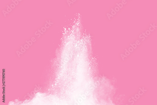 White powder explosion on pink background. White dust splash cloud on pink background.
