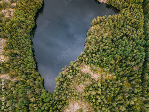 Aerial view of blue lakes and green forests on a sunny summer day in Pentala island museum, Finland © xan844