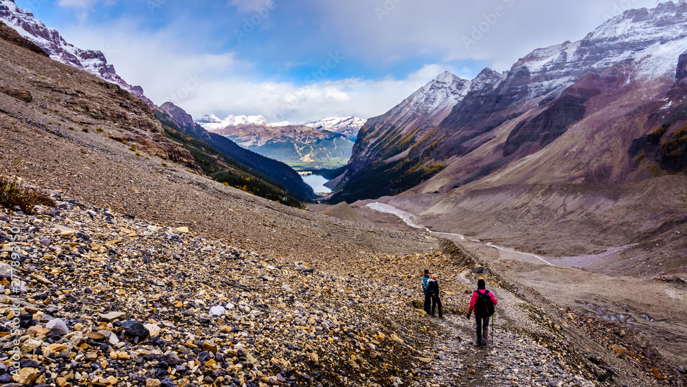 Hiking in the Mountains surrounding the moraines of Victoria Glacier on the hiking trail to the Plain of Six Glaciers at Lake Louise in Banff National Park, Alberta, Canada