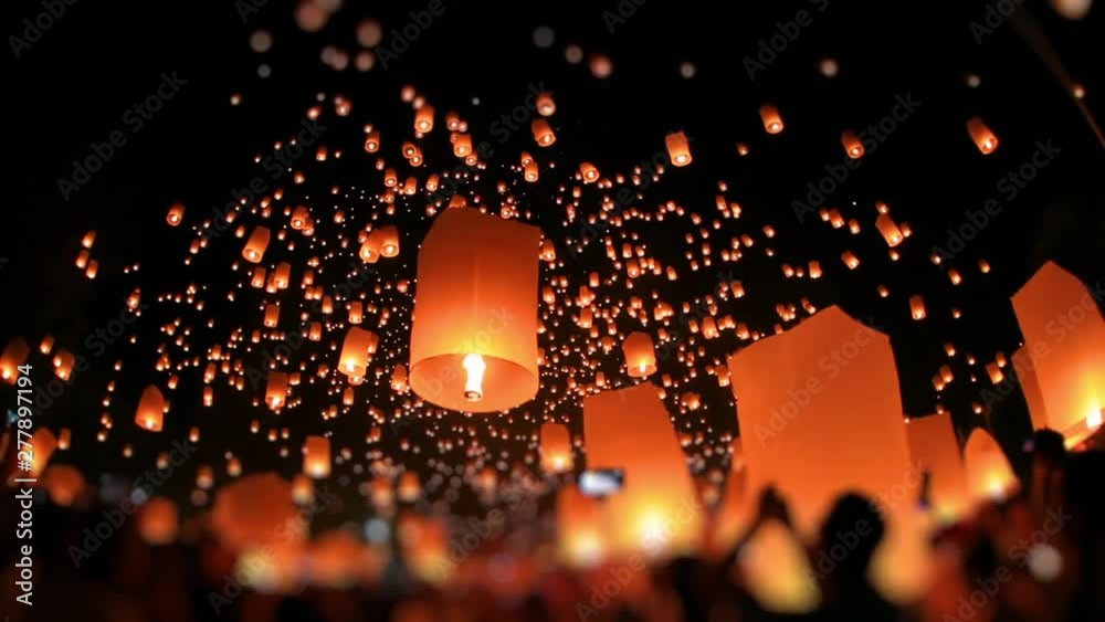 Amazing lanterns of light is released into the night sky by multi ethnic crowd. Celebrate lantern festival of light in Yeepeng festive at Chiangmai, Thailand. Low angle, extreme wide shot. Tilt-Shift.