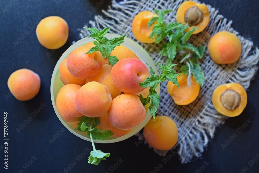 Delicious,sweet apricots and a sprig of mint on the burlap.