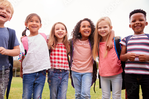 Portrait Of Excited Elementary School Pupils On Playing Field At Break Time