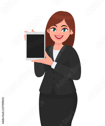 Happy young business woman showing or holding a brand new digital tablet computer in hand. Female character design illustration. Modern lifestyle, technology gadget concept in vector cartoon style.