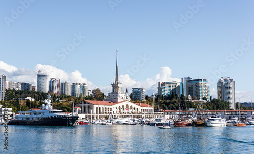 The building of the Sochi sea station and the yacht on the pier photo